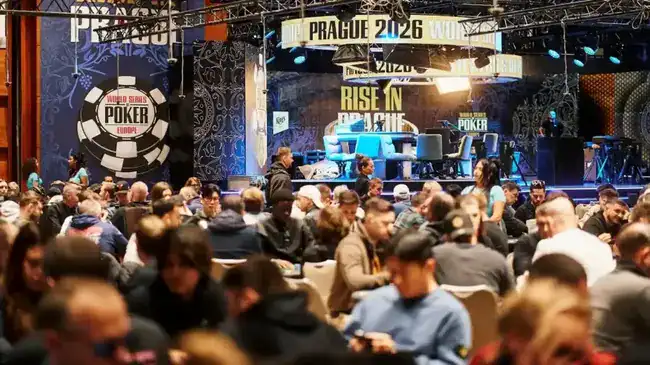A packed poker tournament room at the 2026 World Series of Poker Europe in Prague, with hundreds of players seated at tables and a illuminated 'Rise in Prague' stage in the background.